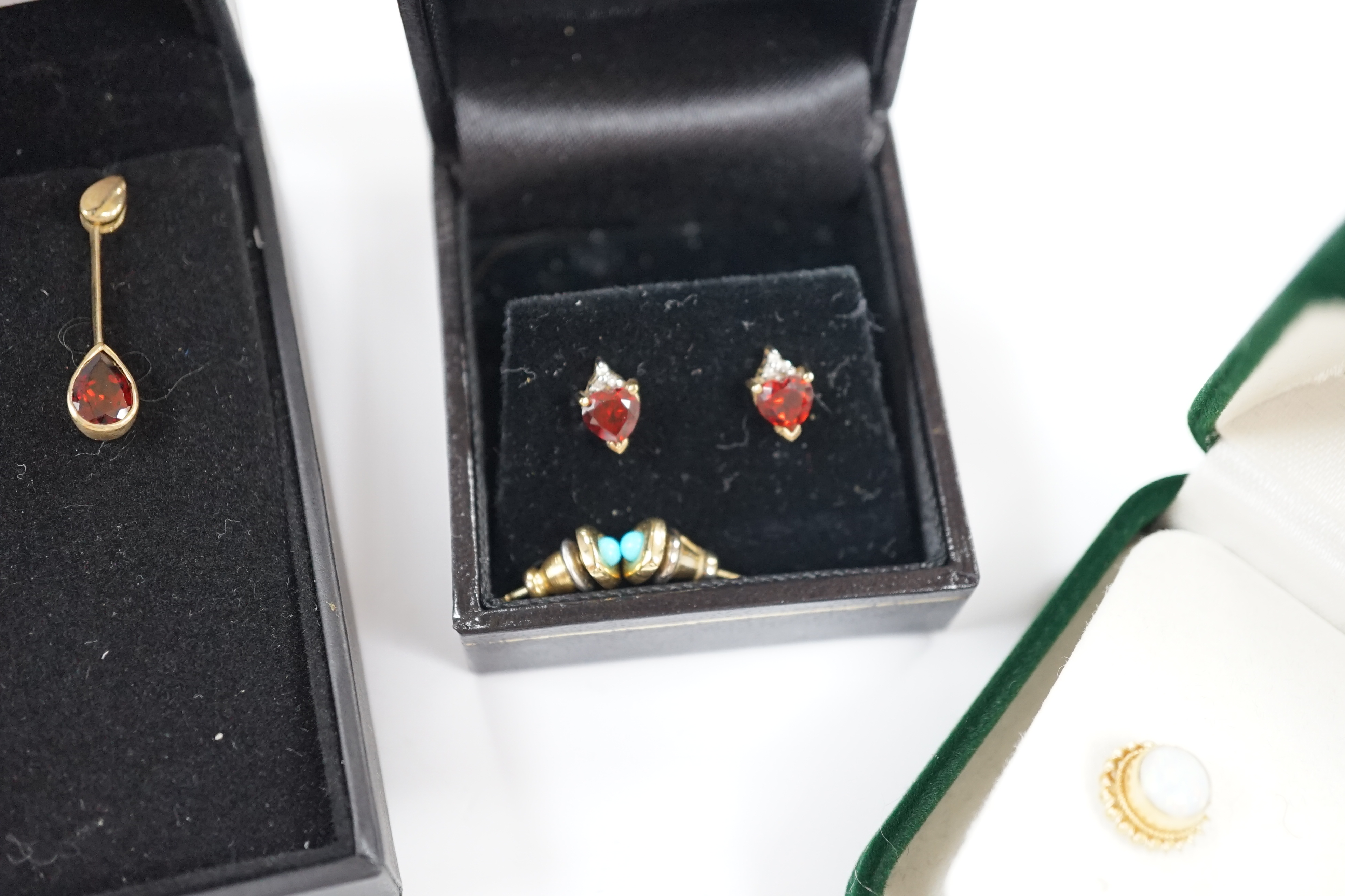 Four assorted pairs of gem set ear studs including 9ct gold and white opal and 9ct gold and garnet.